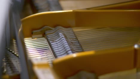 Hammers-of-an-open-concert-grand-piano-moving-during-a-recording-session-in-a-studio-Racking-Focus