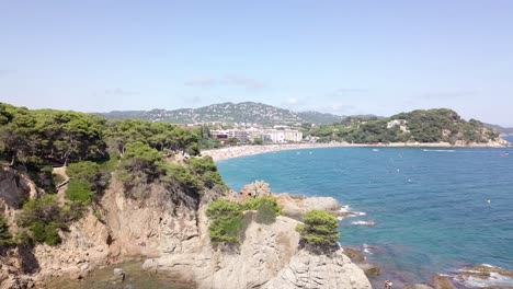 Drone-footage-of-the-tourist-beach-of-Lloret-de-Mar-in-mid-summer
