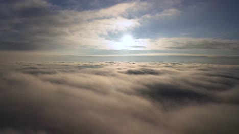 Beautiful-calming-aerial-view-over-the-clouds-from-airplane