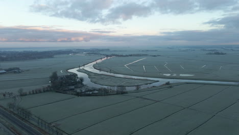 Aerial-of-small-island-in-river-in-frozen-rural-landscape