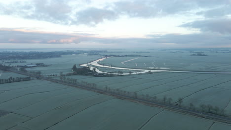 Stunning-aerial-of-frozen-rural-Dutch-countryside-at-dawn