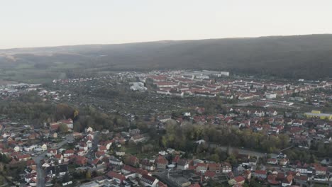 Drone-Aerial-view-of-Thale,-the-Rosstrappen,-Hexenstieg,-Hexentanzplatz-and-the-Bodetal-in-the-north-of-the-Harz-national-Park-in-late-autumn-at-sunset,-Germany,-Europe