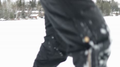 Cinematic-rough-jerky-camera-action-of-a-man-walking-in-and-out-of-focus-in-snow-shoes-in-the-Canadian-arctic