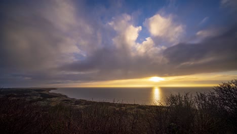 Beautiful-sun-setting-over-the-land-and-sea-of-Ameland,-Netherlands--time-lapse