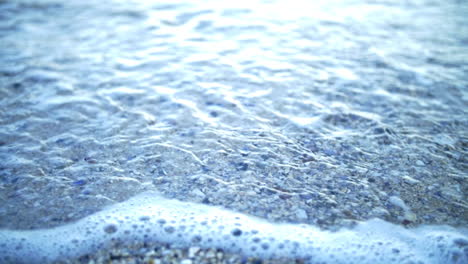 Waves-Washing-In-Stony-Shoreline-During-Sunny-Morning