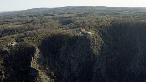 Drone-Aerial-view-of-Thale,-the-Rosstrappen,-Hexenstieg,-Hexentanzplatz-and-the-Bodetal-in-the-north-of-the-Harz-national-Park-in-late-autumn-at-sunset,-Germany,-Europe