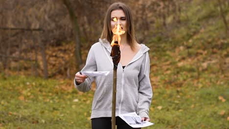 Sad-Vocalist-Girl-Singing-And-Burning-Photos-With-Torch