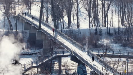Creative-cinemagraph-of-winter-jogger-crossing-footbridge-over-river