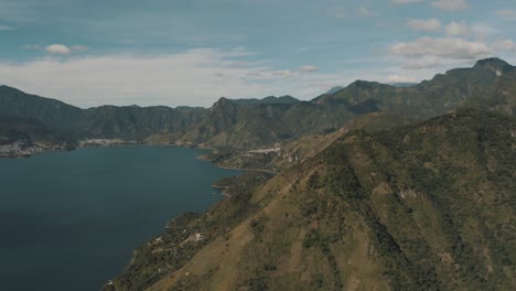 Drone-aerial-view-of-the-beautiful-green-mountains-surrounding-lake-Atitlan-in-Guatemala