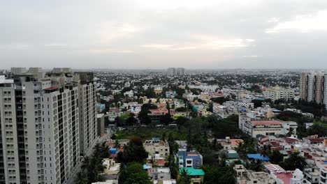An-aerial-drone-shot-of-buildings,-city-buildings-during-sunset,-Chennai-City---Chennai,-on-the-Bay-of-Bengal-in-eastern-India,-is-the-capital-of-the-state-of-Tamil-Nadu