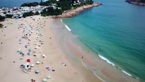 A-static-aerial-view-of-a-yacht-at-the-Shek-O-beach-in-Hong-Kong-as-public-beaches-reopening,-after-months-of-closure-amid-coronavirus-outbreak,-to-the-public