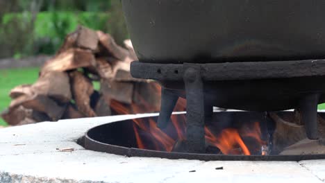 An-old-fashioned-iron-kettle-over-the-fire-of-an-outdoor-campfire