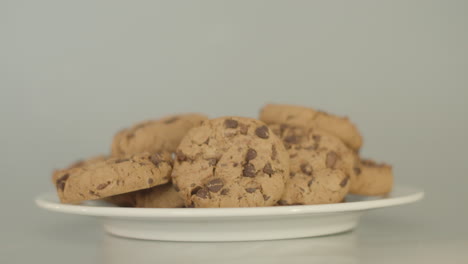 Pile-of-chocolate-chip-cookies-on-a-white-plate---dolly-right