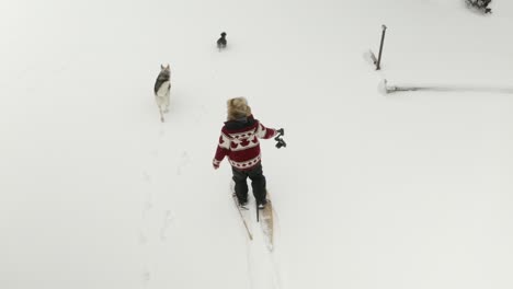 Adult-man-in-large-fur-hat-films-himself-walking-in-snow-shoes-with-a-DJI-Ronin-RSC-2-gimbal