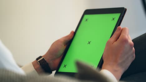 Male-hands-using-black-tablet-with-green-screen-and-tracking-markers