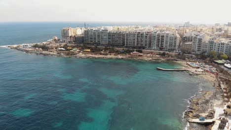Aerial-Push-In-Wide-Shot-Of-Exiles-Bay-in-Sliema-Malta