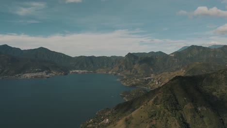 Drone-aerial-landscape-overview-of-lake-Atitlan-in-Guatemala-surrounded-by-volcanoes-and-mountains