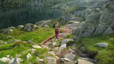 Sport-holiday-maker-woman-go-hiking-near-a-blue-lake