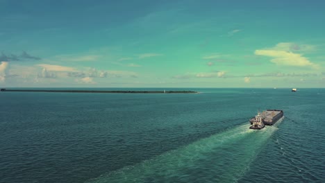 Barcaza-Y-Bote-De-Empuje-Cerca-De-Un-Faro-En-La-Isla-De-Egmont-En-La-Bahía-De-Tampa,-Florida