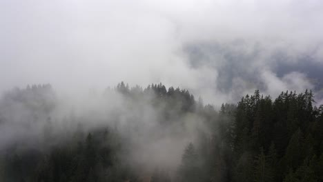 Dramatic-low-clouds-obscure-the-valley-floor-in-the-mountains-of-the-alps