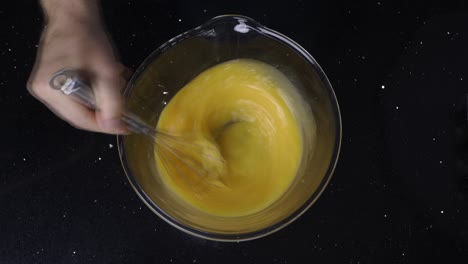 Topdown-view-of-whisking-eggs-in-a-bowl