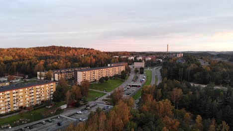 Gothenburg-suburb-area,-Sweden,-aerial-drone-flying-forward-towards-block-residential-buildings,-sunset