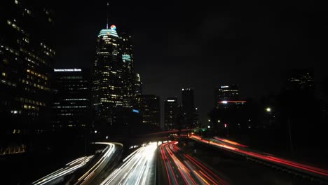 Downtown-Los-Angeles-cityscape-timelapse-nightlife-traffic-light-trails-from-driving-vehicles