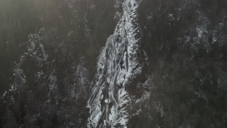 Glacier-Waterfalls-Flowing-From-Forest-Mountain-In-Vallee-Bras-du-Nord-At-Saint-Raymond,-Canada-During-Winter