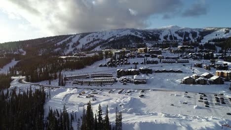 Aerial-View-of-Big-White-Ski-Resort,-Popular-Skiing-Destination,-Kelowna,-Canada-on-Sunny-Winter-Evening,-Drone-Shot