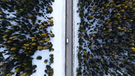 Birdseye-Aerial-View-White-Truck-Moves-at-Straight-Road-in-Cold-Winter-Landscape