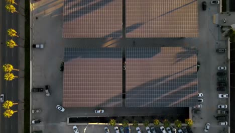 Solar-panels-above-shopping-mall-car-park-in-California,-aerial-bird's-eye-view