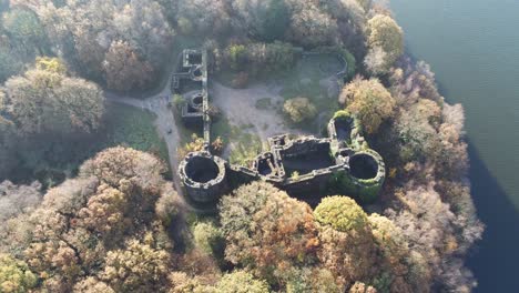Liverpool-castle-replica-ruins-in-Autumn-Rivington-woodland-nature-Landmark-aerial-push-in-descending-view