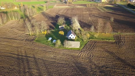 Rural-Farmhouse-on-Agricultural-Property-with-Plowed-Dirt-Fields