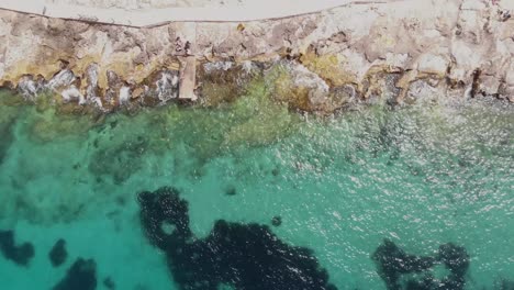 Aerial-Top-Down-Shot-of-A-Rocky-Shore-in-Sliema-Malta