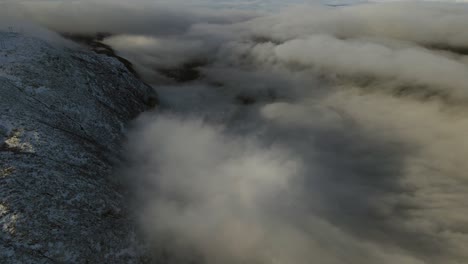 Flying-over-low-clouds-an-valley-at-sunrise-in-Southern-Norway