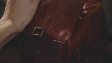 Applying-Wax-To-The-Upper-Body-Of-A-Tan-Leather-Vintage-Backpack-Using-A-Clean-Sponge---Closeup-Shot