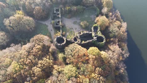 Liverpool-castle-replica-ruins-in-Autumn-Rivington-woodland-nature-Landmark-aerial-tilt-up-view-descending