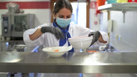 Chef-with-face-mask-prepares-a-plate-with-carrots