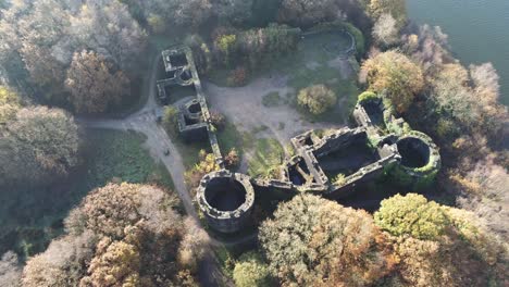Derelict-Liverpool-castle-replica-ruins-in-Autumn-Rivington-woodland-nature-Landmark-aerial-orbit-left-view