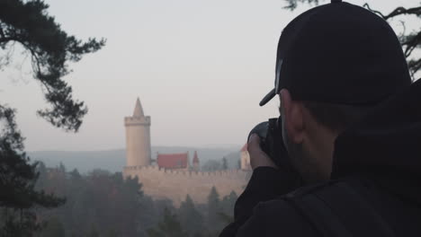 Man-taking-photo-of-Kokorin-castle,-Czech-Republic,-head-closeup-shot