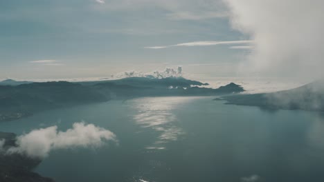 Drone-aerial-landscape-view-flying-high-over-the-clouds-in-lake-Atitlan,-Guatemala