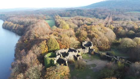 Historic-Liverpool-castle-replica-ruins-in-Autumn-Rivington-woodland-nature-Landmark-aerial-tilt-up-overlooking-countryside-view