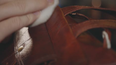 Hand-Polishing-Brown-Leather-Bag---close-up