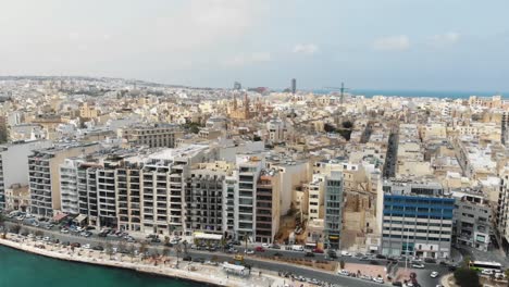 Aerial-Pull-Up-Shot-Revealing-The-Town-of-Sliema-From-The-Coastline