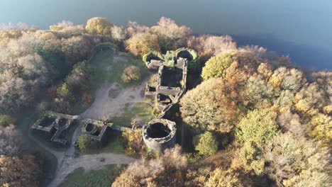 Liverpool-castle-replica-ruins-in-Autumn-Rivington-woodland-nature-reservoir-aerial-top-down-rotate-left