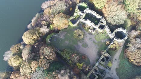 Derelict-Liverpool-castle-replica-ruins-in-Autumn-Rivington-woodland-nature-Landmark-aerial-top-down-descending-view