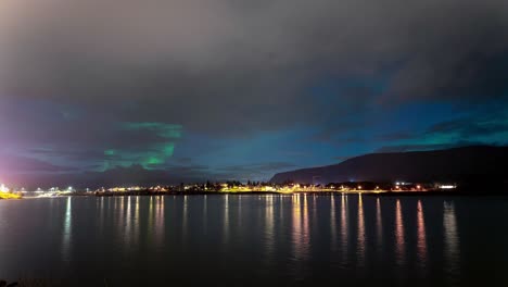 Cloudy-Night-Sky-Timelapse-Of-Aurora-Borealis-By-The-Lake-In-Iceland---wide-shot