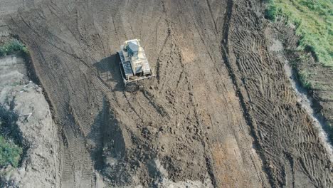 Aerial-top-down-view-of-heavy-duty-excavator-moving-gravel-and-rocks