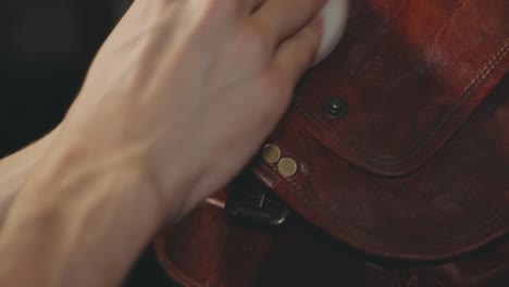 Hand-Image-Polishing-The-Flap-Of-A-Vintage-Leather-Bag