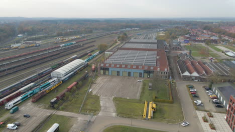 Aerial-tilt-down-of-old-factory-on-trainyard